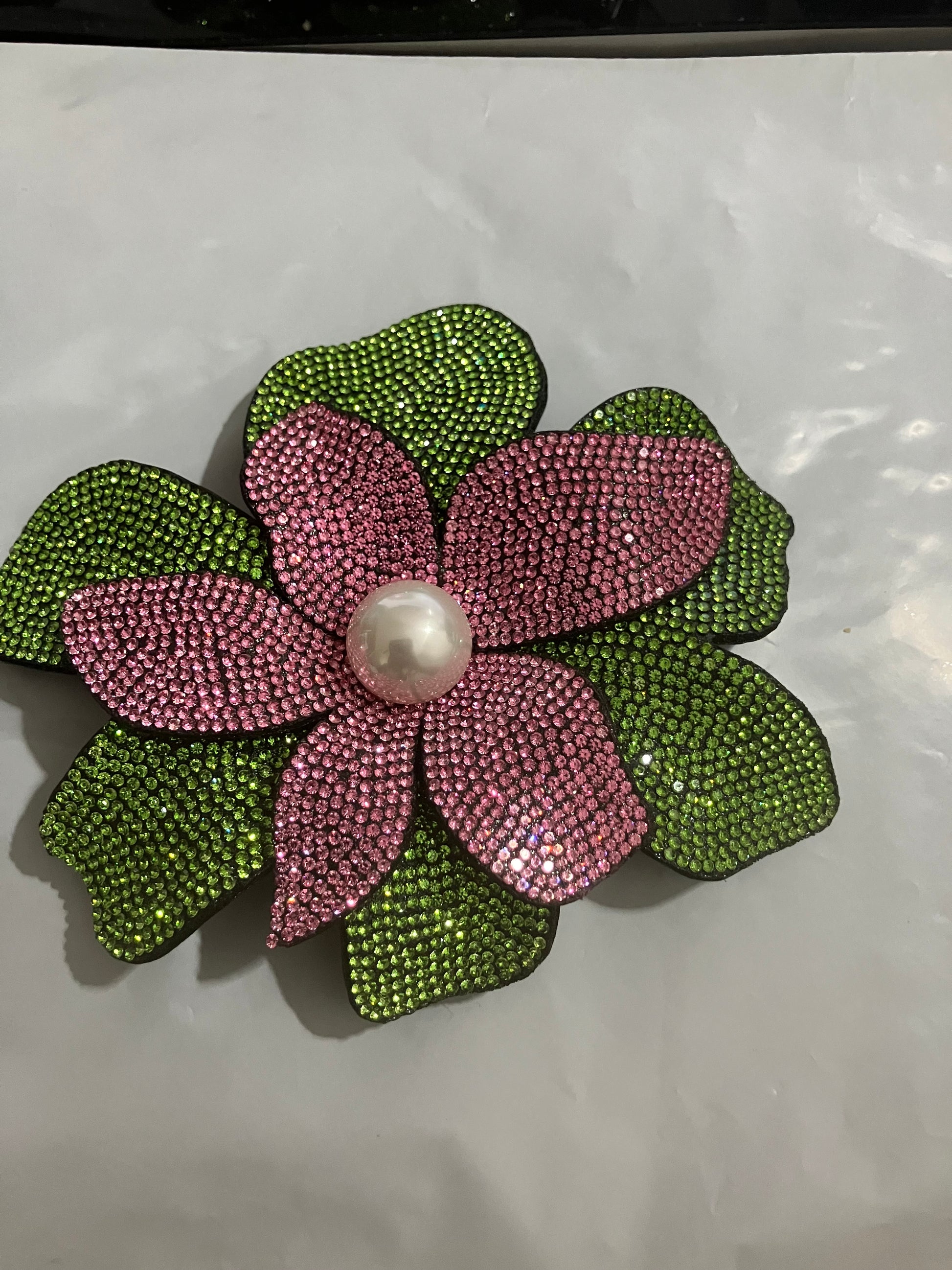 "Sparkling AKA sorority hair clip and lapel pin in official colors"