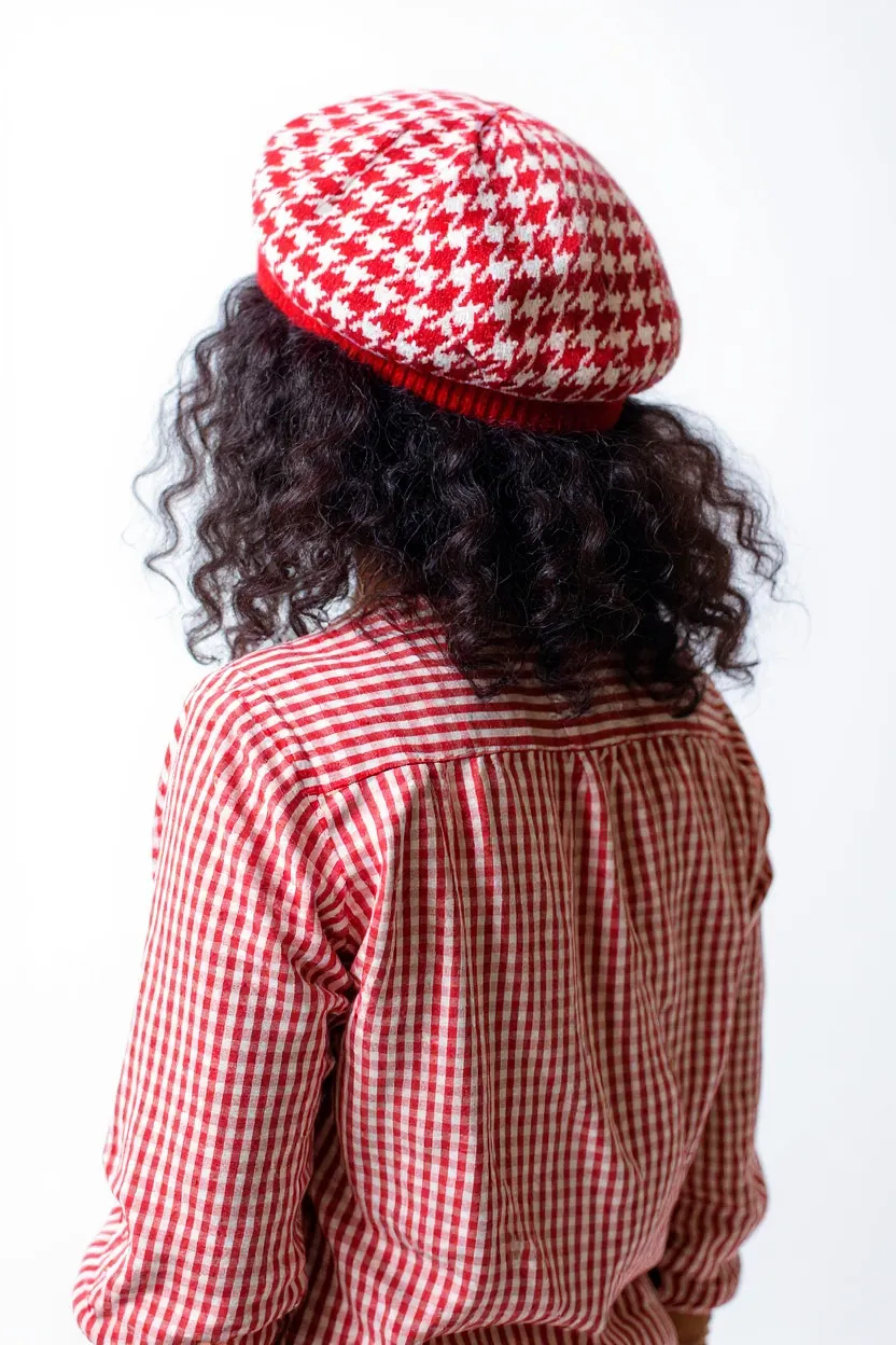 Back view of a woman wearing a red & white beret tam.