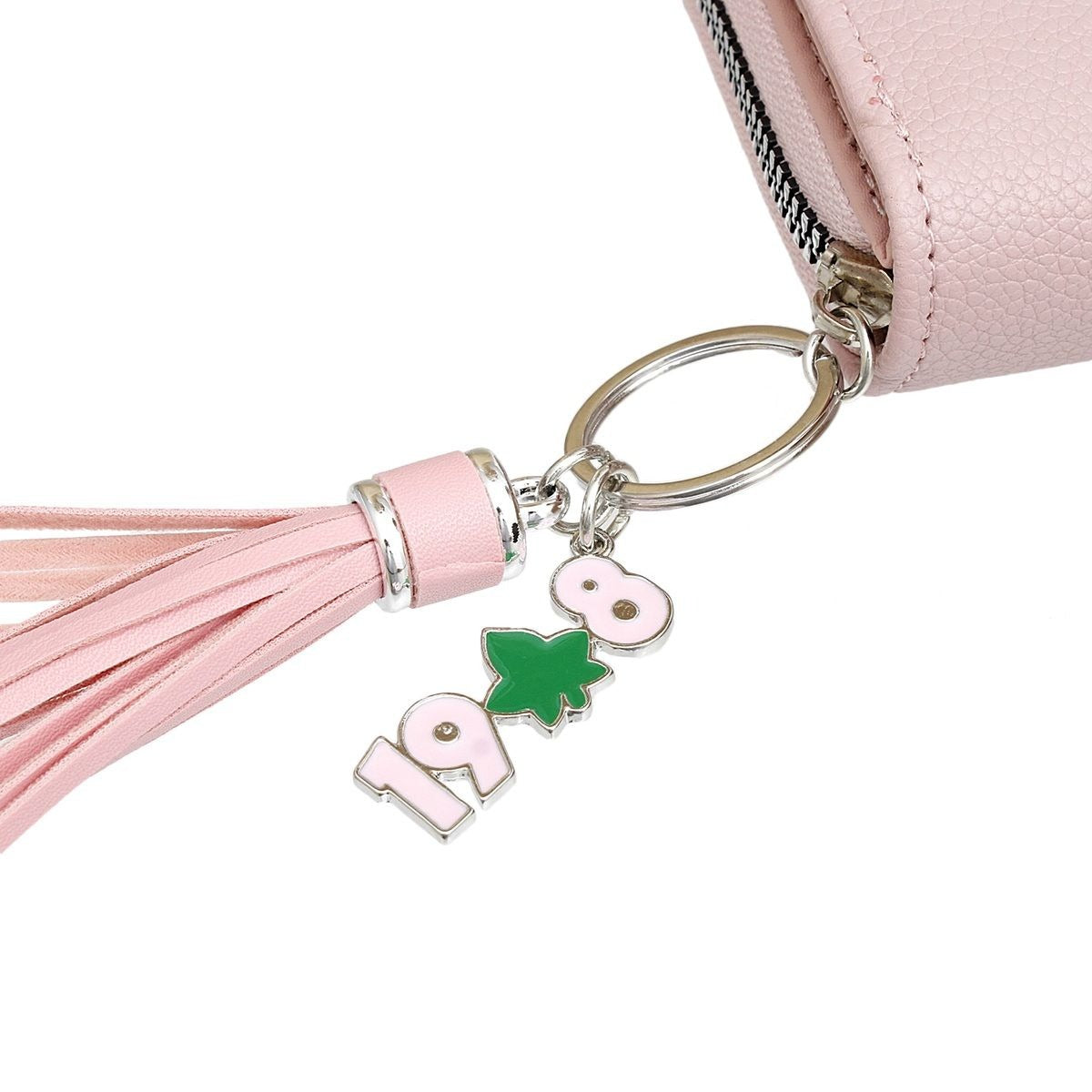 Close-up view of the AKA Wallet with purse charm.