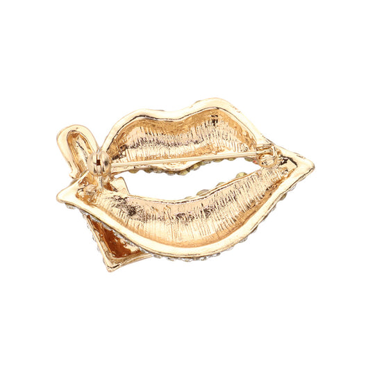 Back view of gold tone lips brooch showing textured metal finish and secure safety pin clasp mechanism.