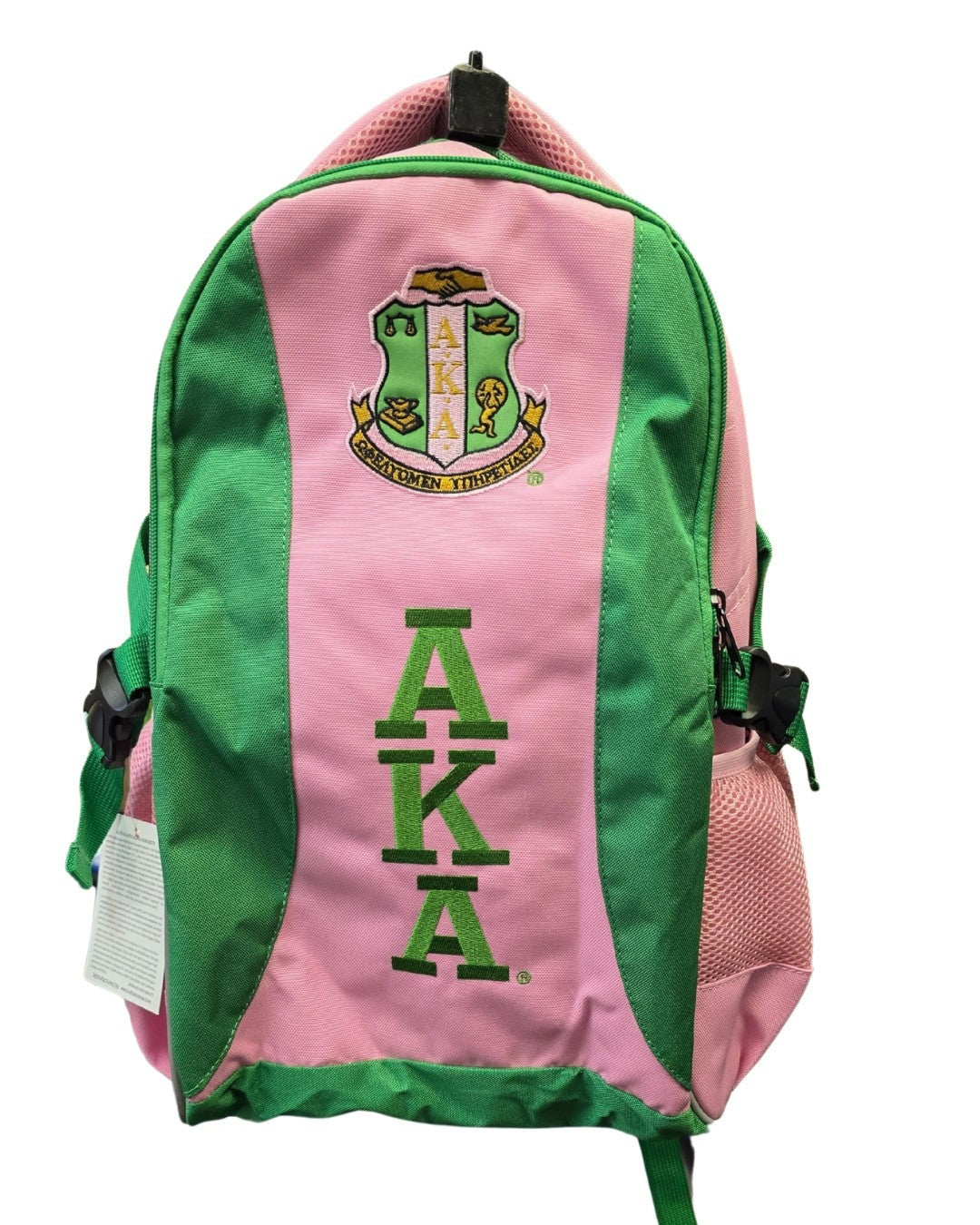 Pink and green backpack with AKA logo on a white background