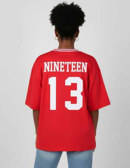 Person wearing a red jersey with 'NINETEEN' and '13' printed on the back against a plain background. Made for members of Delta Sigma Theta Sorority.
