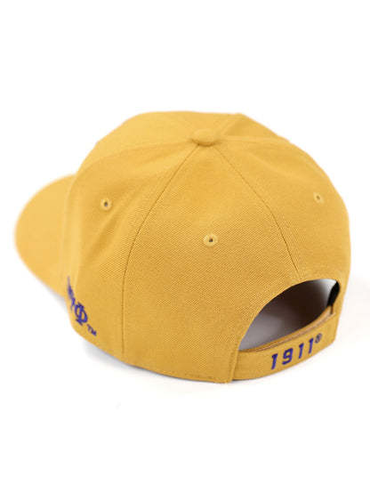 Gold Cap with side view of the Omega Psi Phi Greek Letters and the founding year of 1911 with purple embroidery.