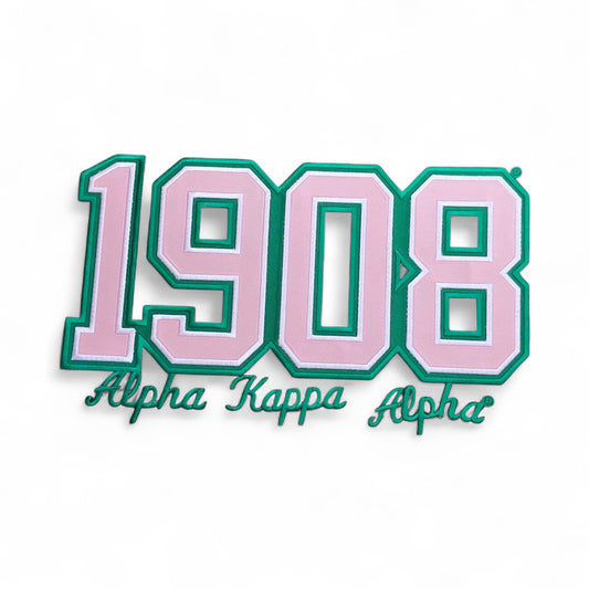 Decorative patch with '1908 Alpha Kappa Alpha' text on a white background