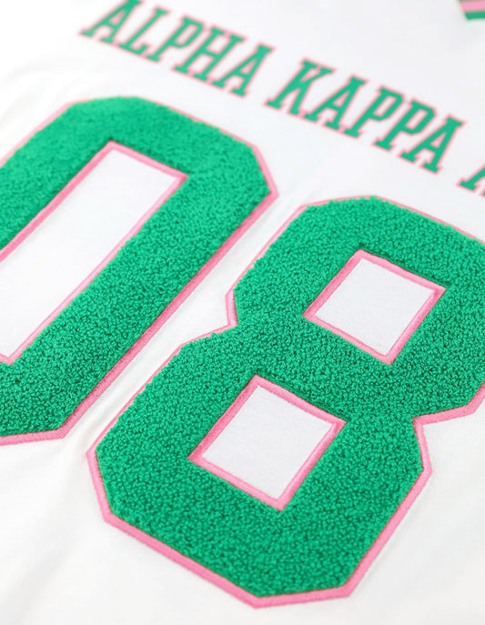 Back view of AKA Loose-Fit Jersey Tee in Ivory with printed IVY LEAF and green "08" numbers.