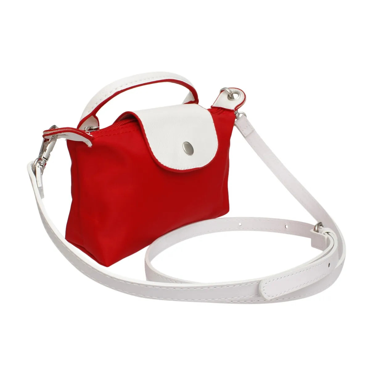 Angled view of the two-tone red and white nylon mini bag. Features top handle, adjustable long strap, and chrome hardware.