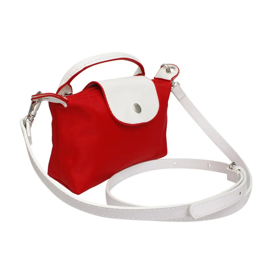 Angled view of the two-tone red and white nylon mini bag. Features top handle, adjustable long strap, and chrome hardware.