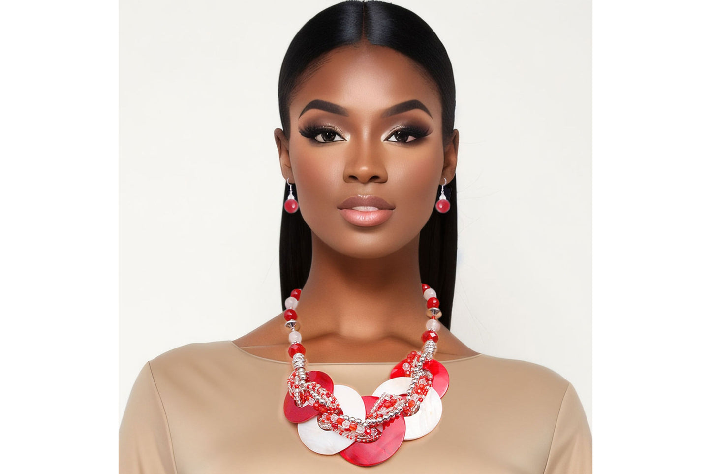 Woman wearing a red and white floral necklace against a plain background