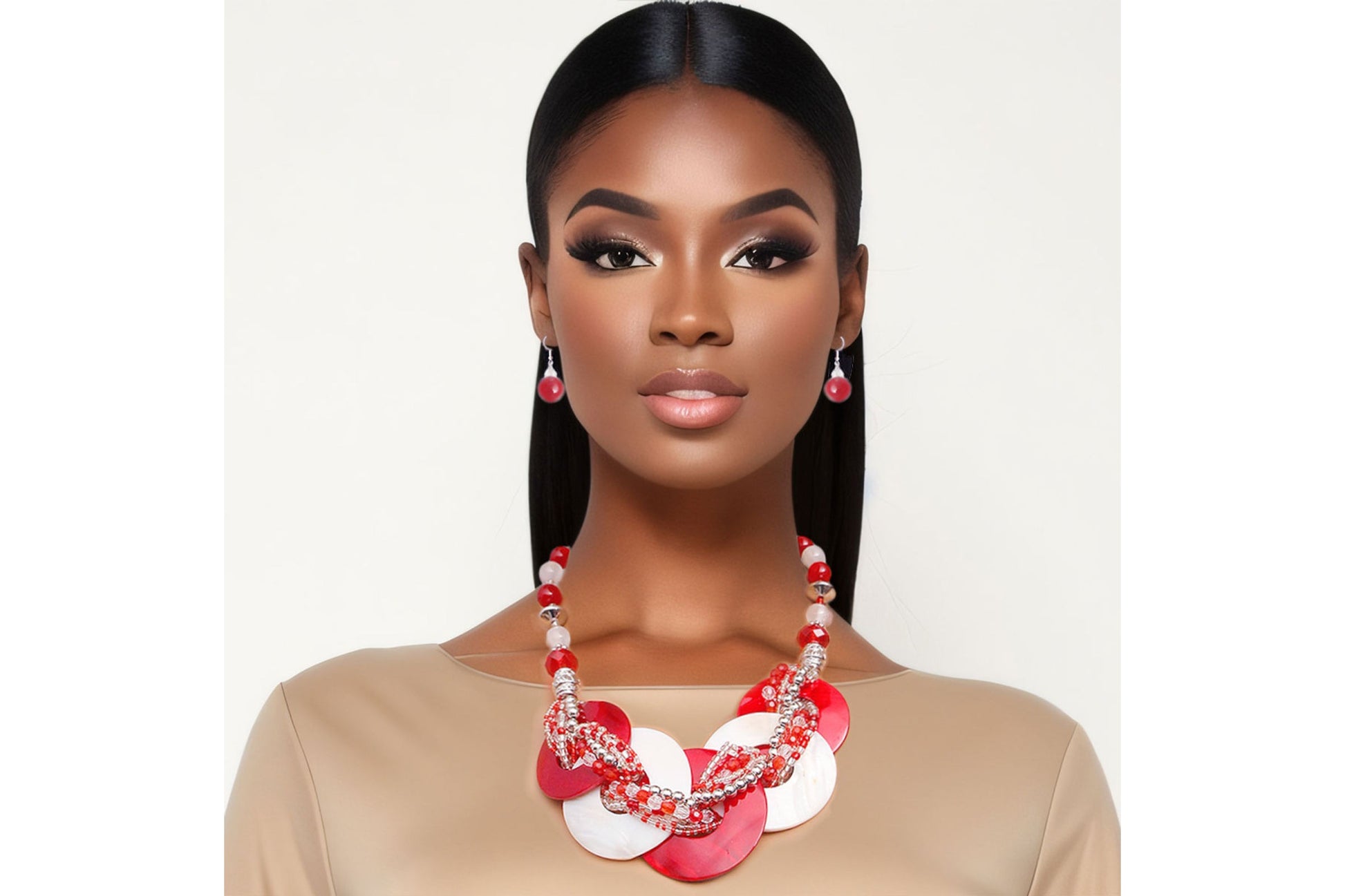 Woman wearing a red and white floral necklace against a plain background